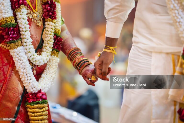 Home indian couple holding hand close up in wedding ceremony.